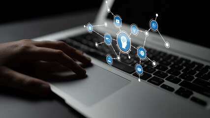 A close-up view of a hand interacting with a laptop keyboard, featuring visual elements of artificial intelligence and digital networking, illustrating modern technology trends. Tessel