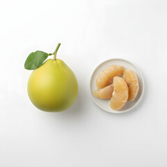 Pomelo Fruit Flat lay composition of a whole fruit with leaf and a side dish of peeled segments