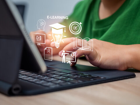 Child using a digital tablet and keyboard for e-learning. Concept of online education, virtual classroom, digital learning, homeschool, and modern technology-based knowledge development for kids.