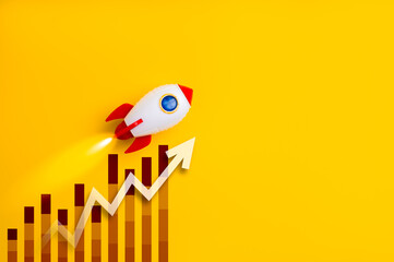 Minimal toy rocket launching over rising bar graph with growing arrow. Concept of business growth,...