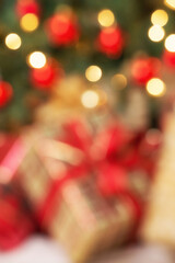 Defocused holiday background of Christmas gifts under the tree, close-up