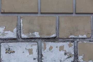 An old beige, peeling brick wall. Construction and renovation. Background. Space for text.