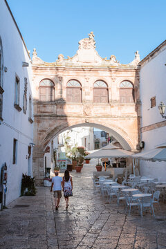 Tourists walking in Ostuni (the White town), Apulia, Italy