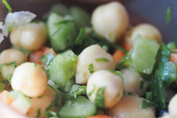Fresh vegetable and chickpea salad bowl with herbs