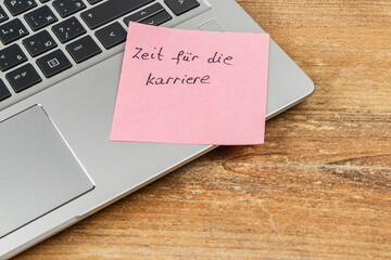 Time for career motivation with sticky note on laptop