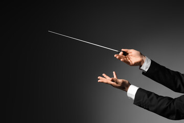 Male conductor's hands on dark background