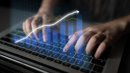 A close-up view of hands typing on a laptop keyboard, with a digital overlay of a growth graph, illustrating business analytics and financial data insights. Impute