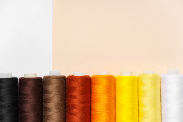 Different thread spools on color background