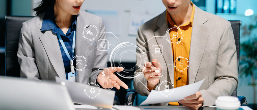 business team working late with AI digital interfaces, data analysis, and fintech tools. Perfect for concepts of technology, innovation, smart office