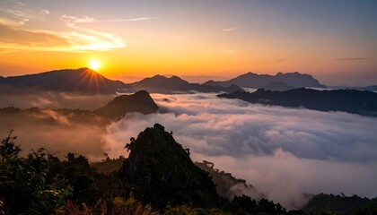 A scenic sunrise paints the sky with golden hues over a cloud-filled valley and distant mountain ranges. The sun shines brightly