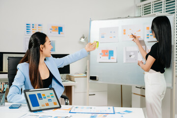 UX UI designers presenting mobile app wireframes and color palettes during a creative startup meeting, showcasing collaboration, planning, and modern design workflow.