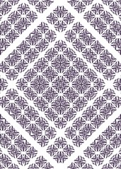 A repetitive geometric pattern in a diagonal arrangement is seen. Dark colored shapes create a mosaic pattern of stars and crosses against a white background.