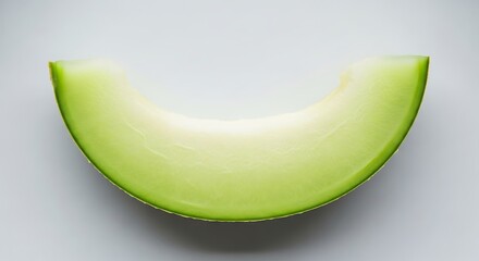 A single slice of honeydew melon on a plain background.