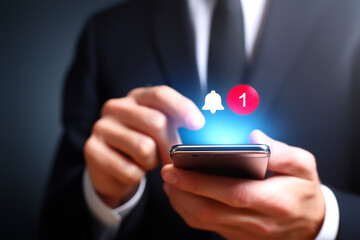 A businessman interacts with a smartphone, highlighted by a notification alert, symbolizing communication and connectivity in the digital age.