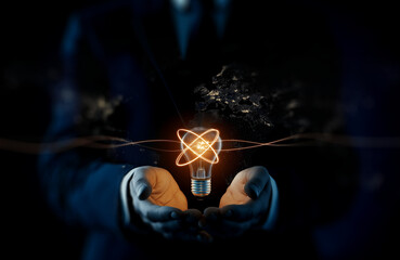 A man in a suit holds a glowing light bulb, symbolizing innovation and ideas, against a dark background.