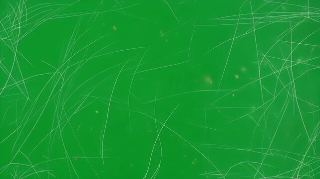 Heavily scratched green surface with random white scuff marks, creating a distressed grunge texture for an abstract vintage background