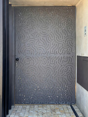 modern entrance grey steel security door with perforated pattern holes for airflow