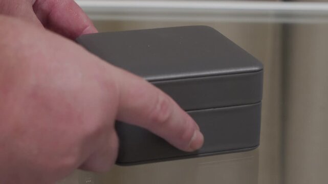 An empty jewelry box is opened and then snapped shut. Both actions produce a short, distinct click from the hinge and clasp.