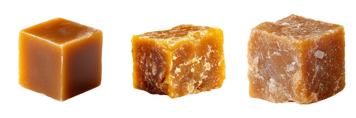 Three blocks of unrefined cane sugar in varying textures and shades of brown isolated on a transparent background