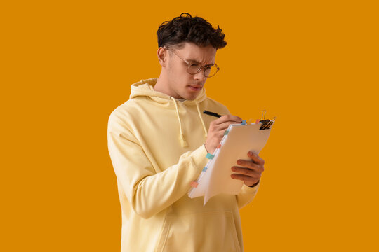 Male screenwriter writing script on yellow background