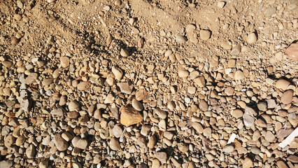 Natural soil and small stone mixture texture with earthy rough ground detail and outdoor terrain pattern for high-quality design use