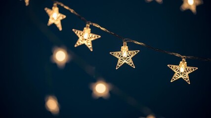 Festive Star-Shaped String Lights illuminate a Dark Night Sky