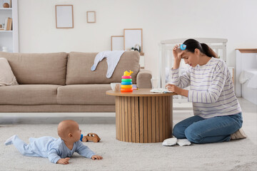 Young mother with bottle and her baby suffering from postnatal depression at home