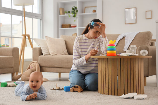 Young mother with bottle and her baby suffering from postnatal depression at home - Powered by Adobe