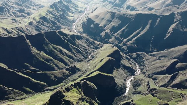Aerial view flying over drakensberg mountains canyon. Media
