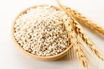 Closeup of barley grains in wooden cup.