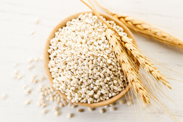 Closeup of barley grains in wooden cup.