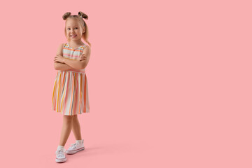 Portrait of adorable little girl on pink background