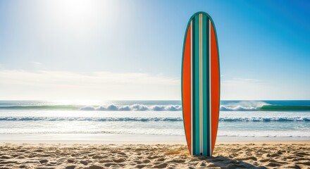 Colorful surfboard standing on sunny beach with ocean waves in background