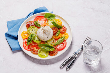 Fresh burrata served on slices of colorful tomatoes