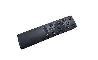 Black universal TV remote control with assorted function buttons placed on isolated white background