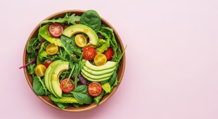 Fresh avocado salad with cherry tomatoes on pink background