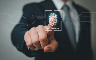 A businessman in a suit presses his finger on a futuristic scanner to authenticate his identity, symbolizing digital security and biometric access control in modern technology