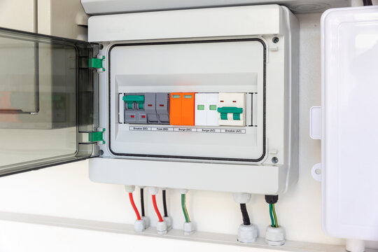 Solar Combiner Box on a House Wall with Integrated DC and AC Safety Components (Breakers, Fuses, Surge Protection) for a Hybrid PV System.