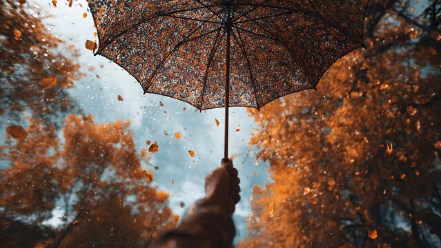 A hand holding an open umbrella against a blurred winter background , providing ample copy space