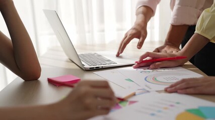 Startup company employee working together using laptop analyzing BI dashboard paper on financial data report and planning strategic marketing for creative business success in panorama video. Synergic - Powered by Adobe