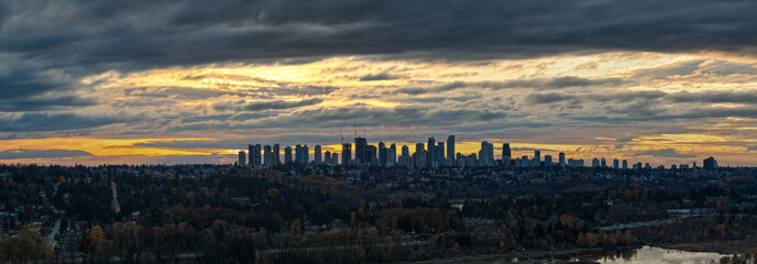 Sunset Over Burnaby Skyline: Dramatic Clouds, Cityscape, and Riverside Foreground in Greater Vancouver