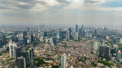 Fototapeta premium Aerial view of Jakarta with skyscrapers and residential areas. Indonesia.
