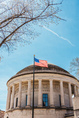 American Flag Over Classical Rotunda With Columns Under Clear Blue Sky - Patriotic Civic Image
