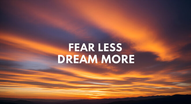 Inspiring 'Fear Less Dream More' quote over a vibrant, fiery sunset sky, evoking ambition and hope for a brighter future.