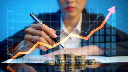 A businesswoman analyzes growth using stacked coins, financial data graphs and a pen. Shot against a blue background. The image emphasizes investment success. - Powered by Adobe