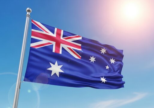 Australian national flag waving in the wind against a clear blue sky day