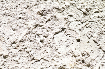 Close-Up Of Rough Light Beige Rock Surface With Texture, Cracks, And Shadows