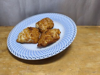 Fried tempeh on a plate as a delicious side dish for the whole family. Suitable for menus, recipes, and advertisements. Close-up. Text space. Selective focus.