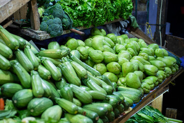 Fresh Pile of Green Zucchinis and Chayotes in a Market Stall Display