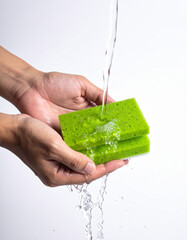 Greenwash concept: hands with a green sponge